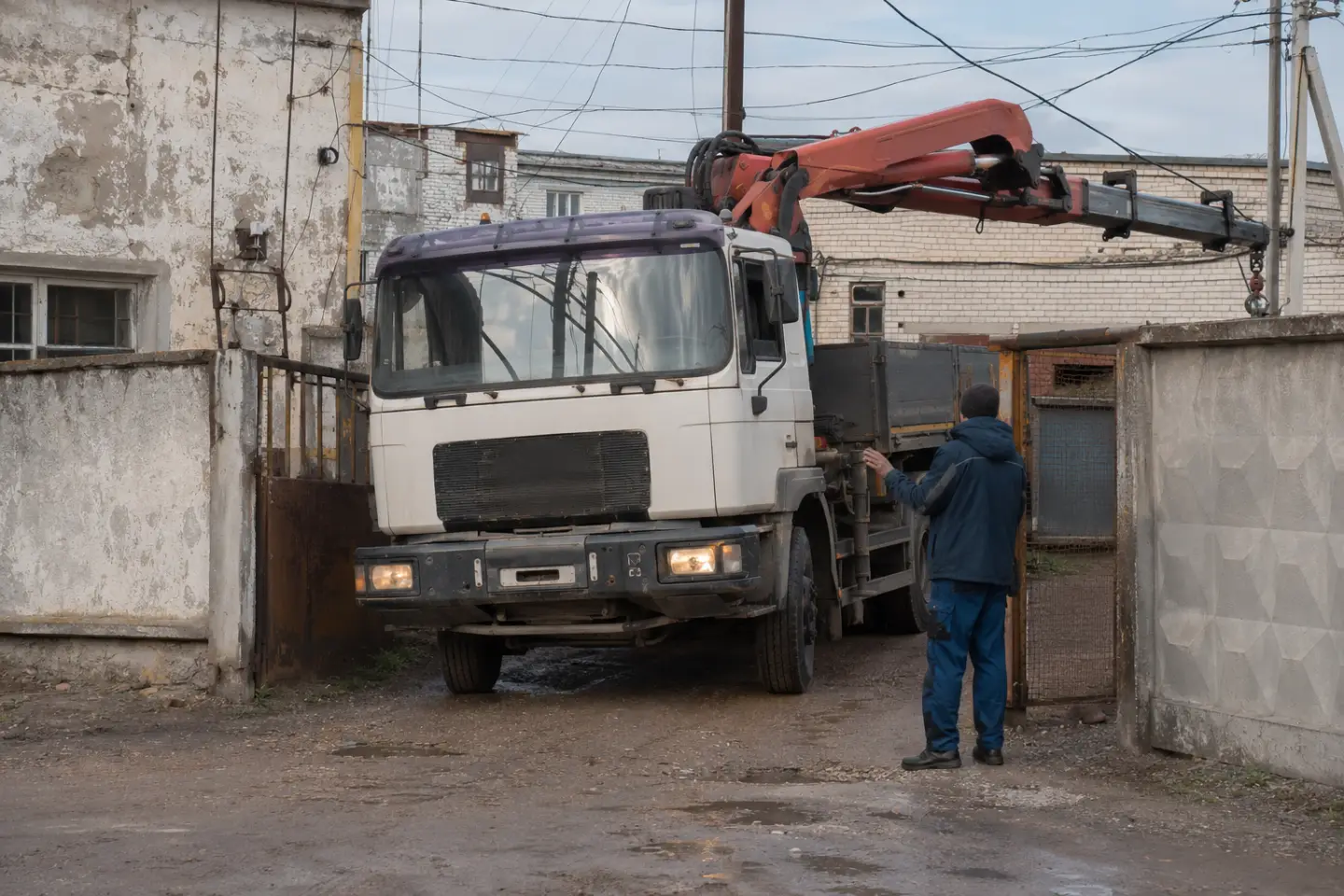 Манипулятор пытается подъехать к промышленному объекту в Гродно через узкий проезд с ограниченным пространством.